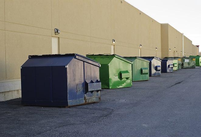 portable, green construction dumpsters serving as a container for scrap materials in Clio